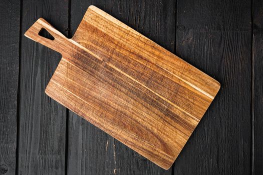 Used bamboo chopping board empty for empty for copy space for text or food, top view flat lay, on black wooden table background