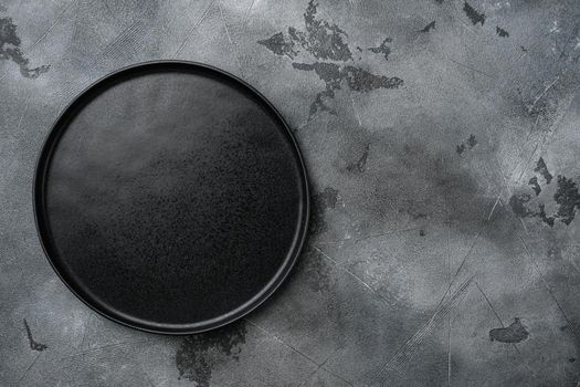 Empty black plate set, on gray stone table background