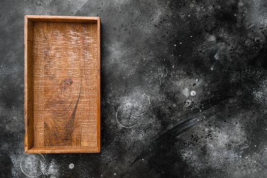 Empty dark wooden box set with copy space for text or food, top view flat lay, on black dark stone table background