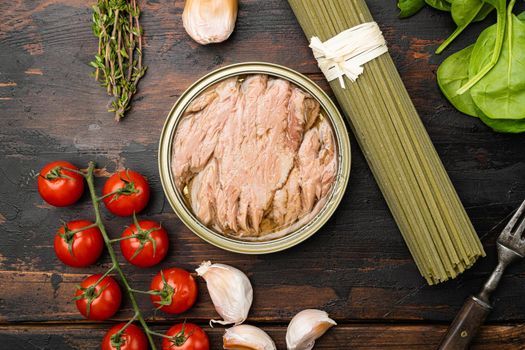 Pasta with tuna raw ingredients set, on old dark wooden table background, top view flat lay