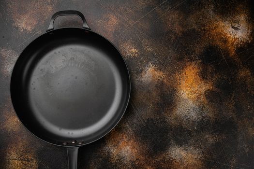 Empty frying pan set with copy space for text or food with copy space for text or food, top view flat lay, on old dark rustic table background