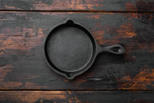 Used old empty frying pan set with copy space for text or food with copy space for text or food, top view flat lay, on old dark wooden table background