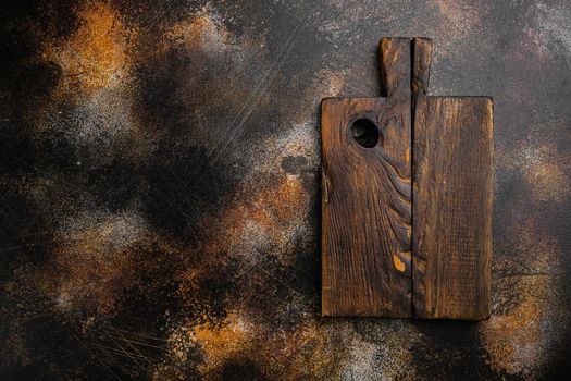 Empty wooden cutting board set, top view flat lay , with copy space for text or food, on old dark rustic table background