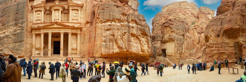 Tourists visiting Petra in Jordan walk or are helped by Bedouin carts 25 February 2020