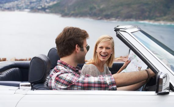 Shot of a young couple enjoying a drive along the coast in a convertible.