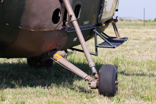 Military Alouette III helicopter landing gear on grass abstract close-up, South Africa