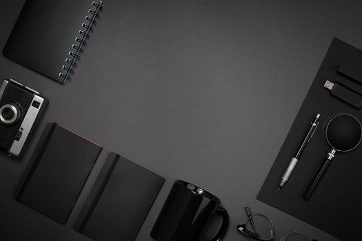 Still life, business, office supplies or education concept : top view image of notepad, mobile phone and coffee cup on black background, ready for adding or mock up