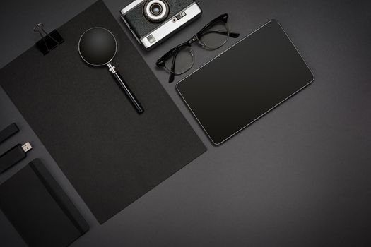 Still life, business, office supplies or education concept : top view image of notepad, mobile phone and coffee cup on black background, ready for adding or mock up