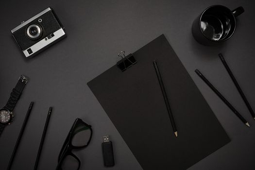 Still life, business, office supplies or education concept : top view image of notepad, mobile phone and coffee cup on black background, ready for adding or mock up