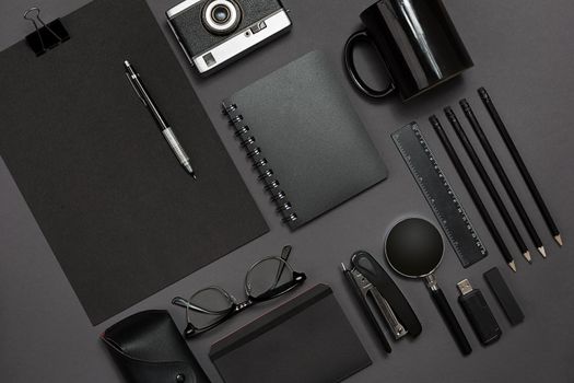 Workplace with office items and business elements on a black background. Concept for branding. Top view. Copy space. Still life