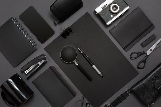 Workplace with office items and business elements on a black background. Concept for branding. Top view. Copy space. Still life