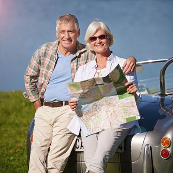 Portrait of a happy senior couple enjoying a road trip together.