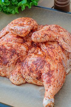 Raw whole chicken on an oven tray. chicken tobacco