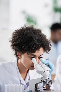 close-up. female scientist looking through a microscope. medical research concept.