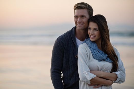 A young couple enjoying a romantic moment together at the beach.