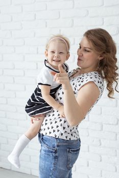 Mother holds her child with hearing aids and cochlear implants . Deaf and health