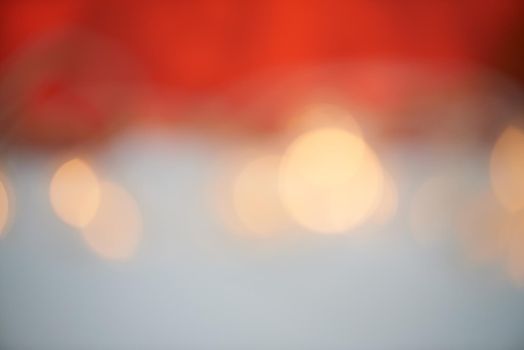 Bokeh lights against a red and grey background.