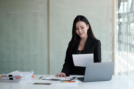 Asian Business Woman or Accountant with paperwork on desk, account, audit and saving concept