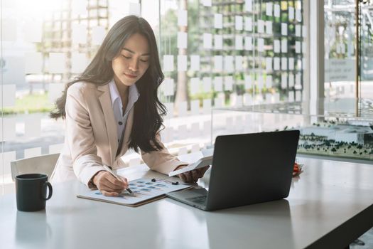 business asian woman working data document graph chart report marketing research development planning management strategy analysis financial accounting calculation.