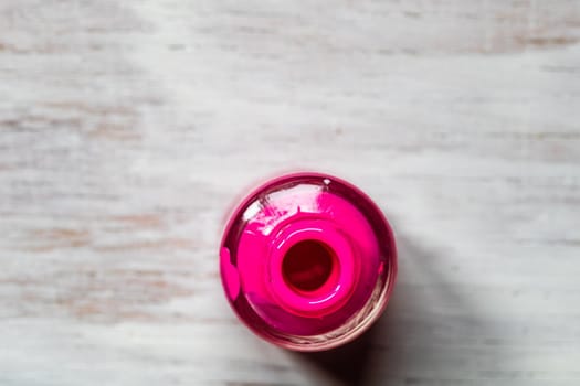 Pink nail polish on white background