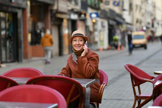 Woman in a hat talking on a mobile phone