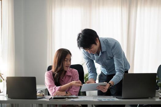 Asian business adviser meeting to analyze and discuss the situation on the financial report in the meeting room.Investment Consultant,Financial Consultant,Financial advisor and accounting concept.