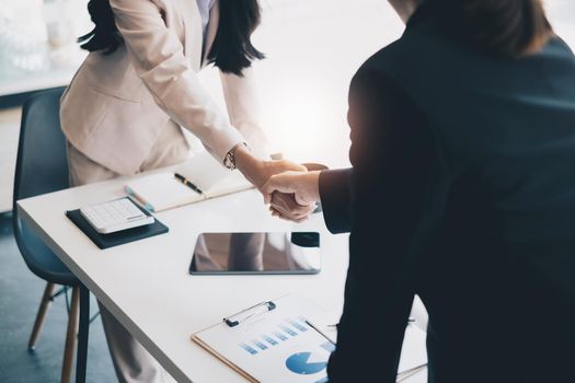 Business partnership meeting concept. Image business women handshake. Successful business people handshaking after good deal. Group support concept