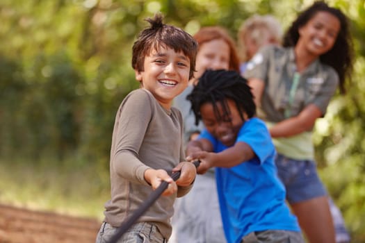 A group of kids in a tug-of-war game.