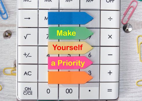 Make Yourself A Priority text is written on the stickers that are on the calculator.