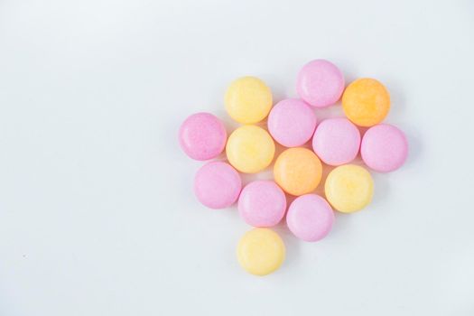 Sweet colorful confectionery, candy on the white background, high angle view
