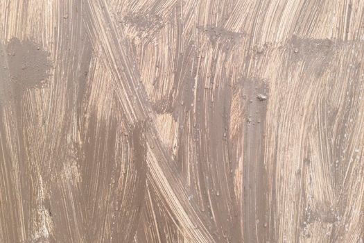 The surface of the iron is casually painted with beige paint. Grunge background.