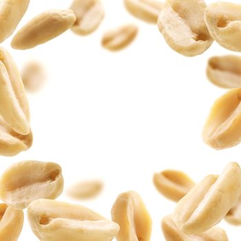 Peeled peanuts levitate on a white background.
