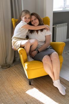Happy loving family. Mother and her daughter child girl hugging at home mothers day concept