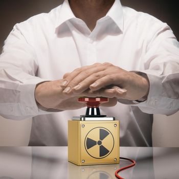 Man pushing a nuke button. Concept of nuclear war. Composite image between a hand photography and a 3D background.