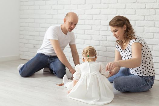 Mother holds her child with hearing aids and cochlear implants . Deaf and health