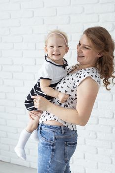 Mother holds her child with hearing aids and cochlear implants . Deaf and health