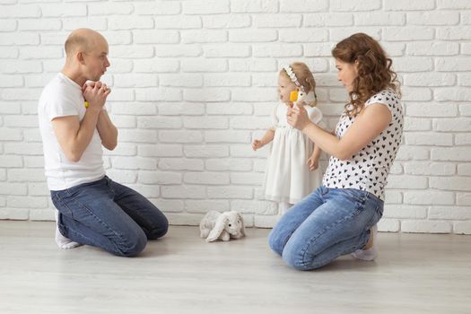 Mother holds her child with hearing aids and cochlear implants . Deaf and health