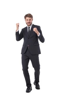 Cheering successful business man holding fists full length studio portrait isolated on white background