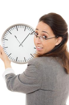 Young business woman smiling holding a clock on white background.