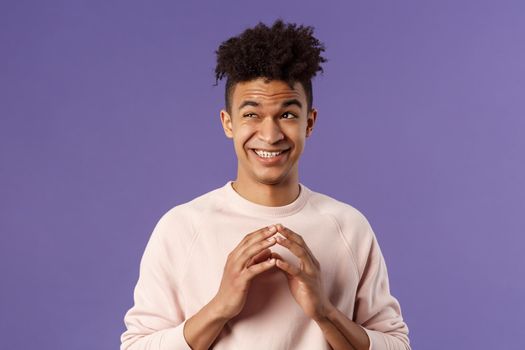 Close-up portrait of creative young hispanic guy steeple fingers while making-up great plan or joke, look away daydreaming, scheming something, have idea, stand purple background.