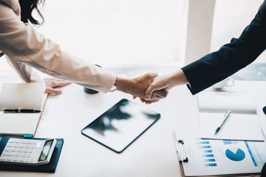 Business partnership meeting concept. Image business women handshake. Successful business people handshaking after good deal. Group support concept