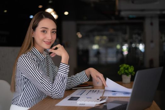 Business woman using laptop computer at office, account or saving money or insurance concept