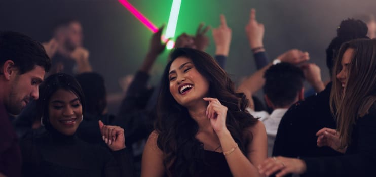 Cropped shot of an attractive young woman dancing in a nightclub.