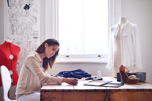 A fashion designer creating sketches in her office.