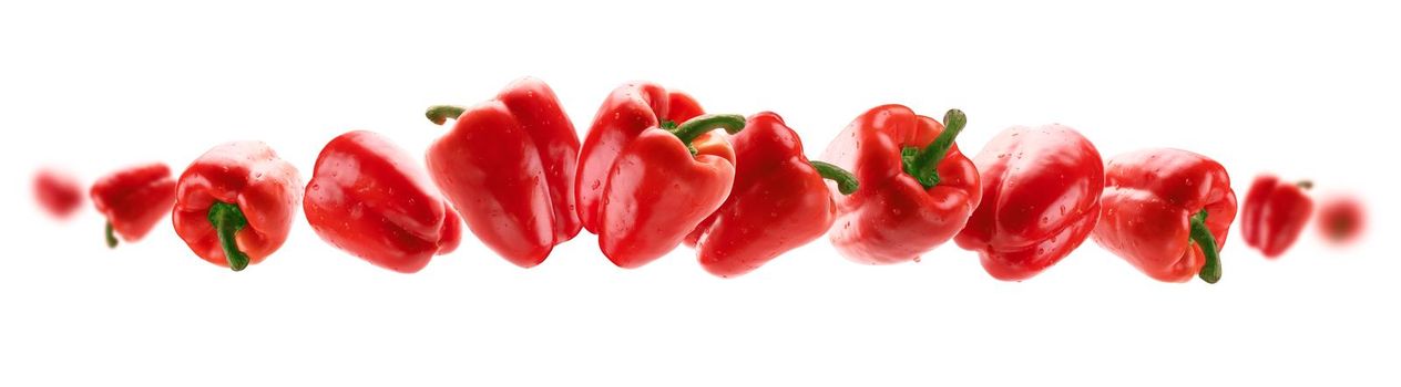 Red paprika levitates on a white background.