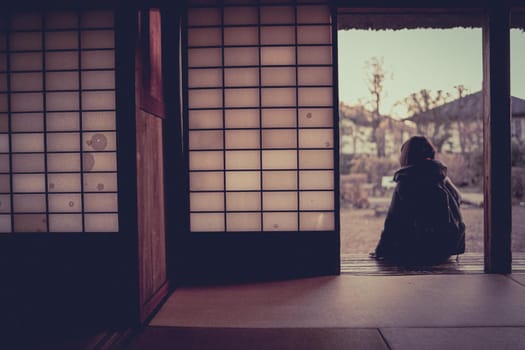 Woman sitting on the edge of a Japanese house. Shooting Location: Sabae City, Tokyo