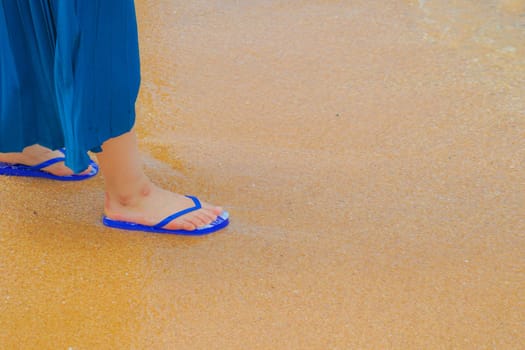 Woman foot walking in the sandy beach. Shooting Location: Thailand, Pattaya