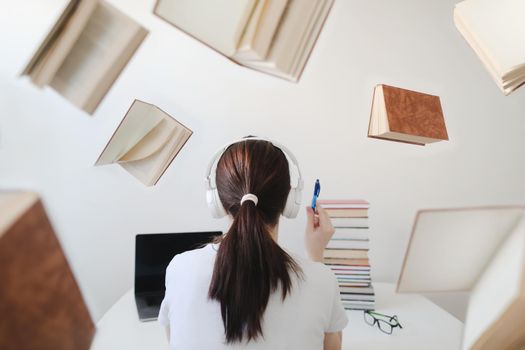 Portrait of a female student with books and glasses. Young female student reading books and preparing for exams. Creative photo