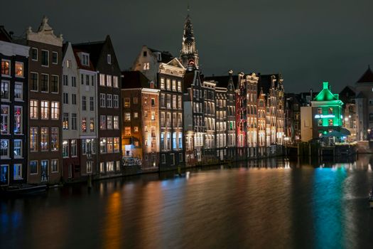 City scenic from Amsterdam at the Damrak in the Netherlands at night