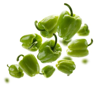 Green paprika levitates on a white background.